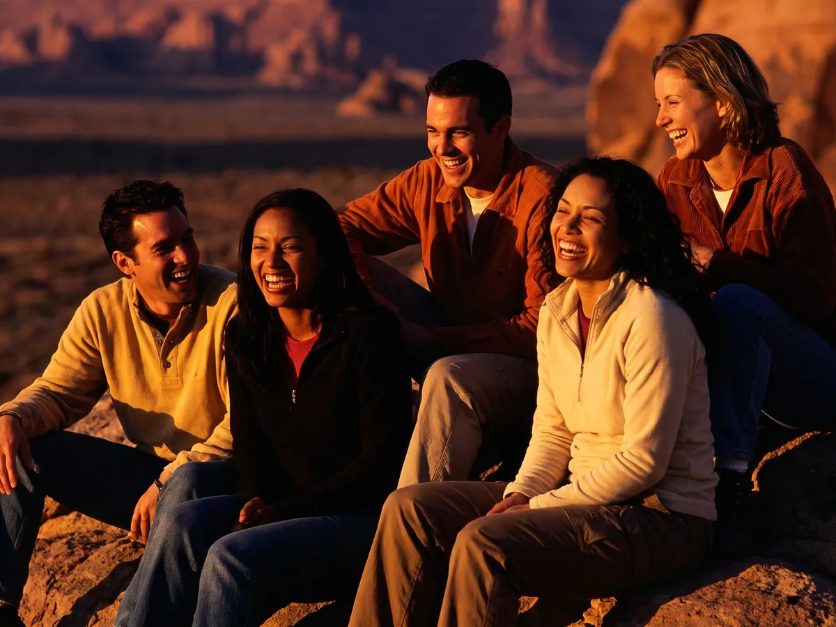 Friends laughing together at sunset